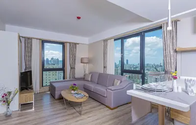 a living room with a couch and a table at Bof Hotels Ceo Suites Atasehir in Istanbul