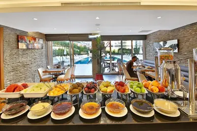 a buffet with many plates of food on a table at Bof Hotels Ceo Suites Atasehir in Istanbul