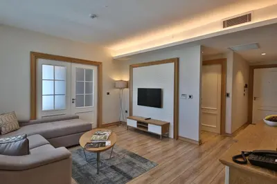 a living room with a couch and a tv at Bof Hotels Ceo Suites Atasehir in Istanbul