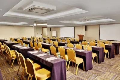 a conference room with tables and chairs and a podium at Bof Hotels Ceo Suites Atasehir in Istanbul