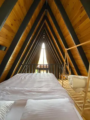 a bed in a room with a wooden ceiling at Golyaka Stone Garden Hotel in Orhangazi