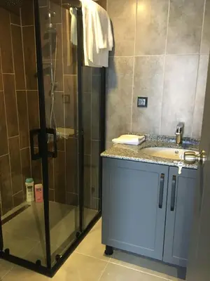a bathroom with a shower and a sink at Golyaka Stone Garden Hotel in Orhangazi