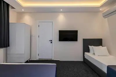a bedroom with a bed and a tv on a wall at Brk Dream Suites Taksim in Istanbul
