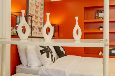four white vases sitting on a shelf in a room at Studio Apartment in Istanbul