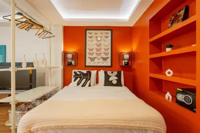 a bedroom with orange walls and a bed at Studio Apartment in Istanbul