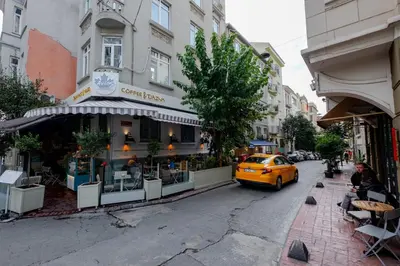 a yellow taxi cab parked in front of a restaurant at Studio Apartment in Istanbul