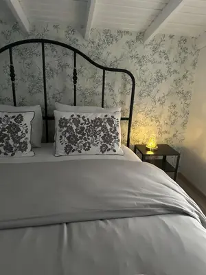 a bedroom with a white bed with floral wallpaper at Luxury Big Villa in Sapanca with Pool SKMaxx in Sapanca