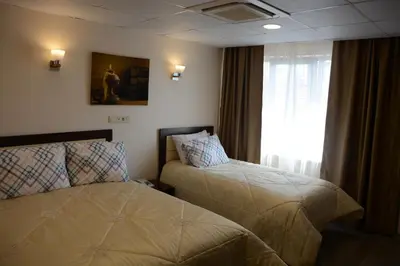 a hotel room with two beds and a window at STS Hotel Luleburgaz in Lüleburgaz