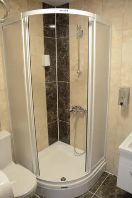 a shower stall in a bathroom with a toilet at STS Hotel Luleburgaz in Lüleburgaz