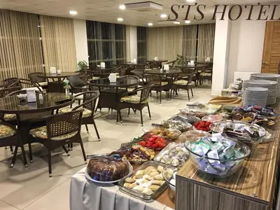 a buffet line in a restaurant with tables and chairs at STS Hotel Luleburgaz in Lüleburgaz