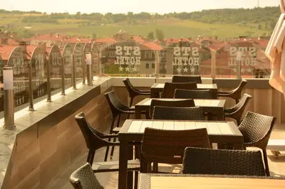 a row of tables and chairs on a balcony at STS Hotel Luleburgaz in Lüleburgaz