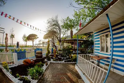 a blue and white house with a garden at Devrim Apart in Ocaklar