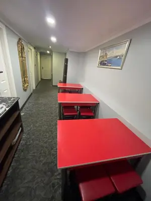 a row of red tables in a room at Hotel Grand Ömer in Istanbul