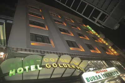 a hotel building at night with a neon sign at Golden Pen Hotel in Istanbul