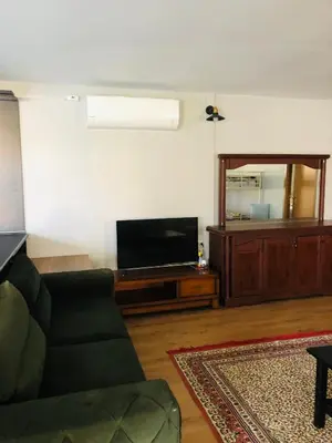 a living room with a couch and a flat screen tv at Polonezköy butik bahçeli ev in Beykoz