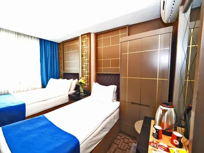 a hotel room with two beds and a tv at Grand Best Nobel Hotel İstanbul in Istanbul
