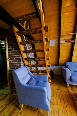 two blue chairs in a room with wooden floors at sapancakelebekvadibungalov in Sapanca