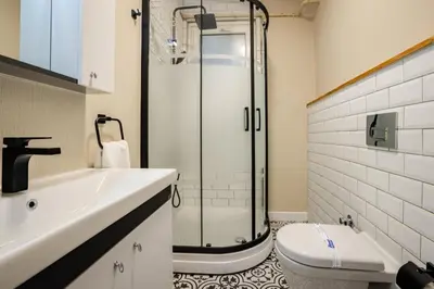 a bathroom with a shower and a toilet and a sink at Elegant 3BD Bosphorus Views Chic Kadıkoy Home #384 in Istanbul