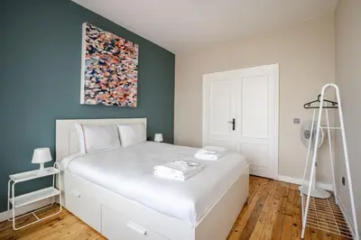 a bedroom with a white bed and a painting on the wall at Elegant 3BD Bosphorus Views Chic Kadıkoy Home #384 in Istanbul