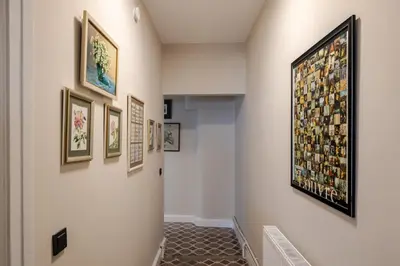 a hallway with framed pictures on the wall at Elegant 3BD Bosphorus Views Chic Kadıkoy Home #384 in Istanbul