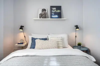 a bedroom with a bed with white sheets and blue pillows at Stay Beyond the Bosphorus #4 in Istanbul