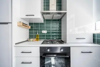 a kitchen with white cabinets and a stove at Stay Beyond the Bosphorus #4 in Istanbul