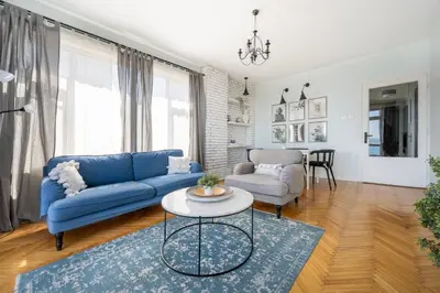 a living room with a blue couch and a table at Stay Beyond the Bosphorus #4 in Istanbul