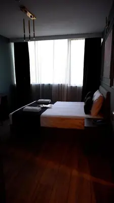 a bed in a room with a large window at Hmz Premium Konaklama Çekmeköy in Çekmeköy