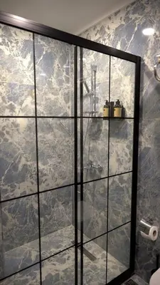 a shower with a glass door in a bathroom at Hmz Premium Konaklama Çekmeköy in Çekmeköy