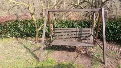 a swing sitting in the grass next to a tree at Değirmenbaşı Otel & Restoran in Ümmiye
