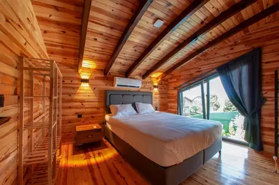 a bedroom with a bed in a wooden house at Rubin Sapanca in Sapanca