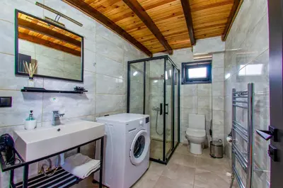 a bathroom with a washing machine and a sink at Rubin Sapanca in Sapanca