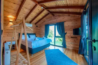 a bedroom with a blue bed in a wooden house at Rubin Sapanca in Sapanca