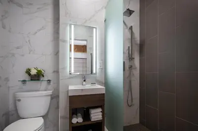 a bathroom with a toilet and a sink and a mirror at Starmax City's Hotel YALOVA in Kâzımiye
