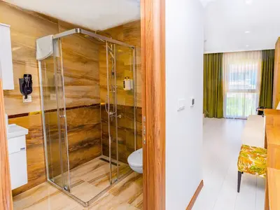 a bathroom with a toilet and a glass shower at Quinnova Hotel in Istanbul