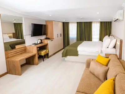 a hotel room with a bed and a couch at Quinnova Hotel in Istanbul