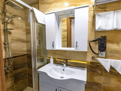 a bathroom with a sink and a shower at Quinnova Hotel in Istanbul