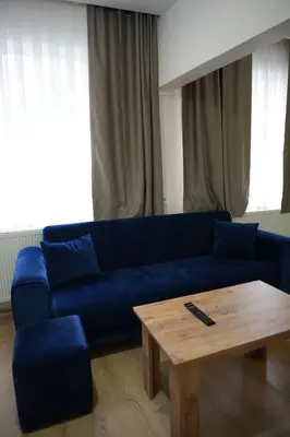 a living room with a blue couch and a coffee table at BDK hotel in Istanbul