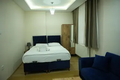 a bedroom with a bed and a blue couch at BDK hotel in Istanbul