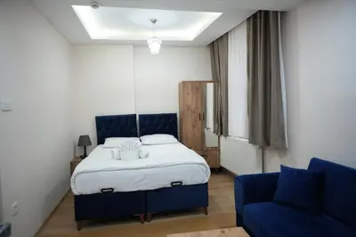a bedroom with a bed and a blue couch at BDK hotel in Istanbul
