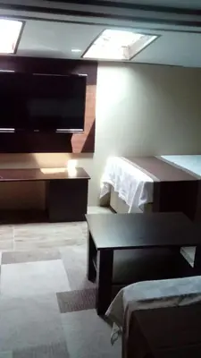 a room with a bed and a tv on the wall at Lena Central Flats in Bursa