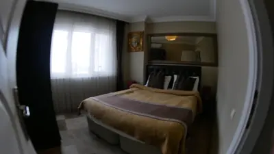 a bedroom with a bed and a window in it at Lena Central Flats in Bursa