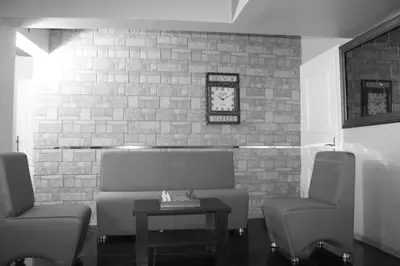a waiting room with two chairs and a table at Lena Central Flats in Bursa