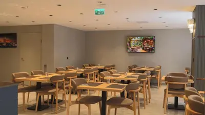 a dining room with wooden tables and chairs at The Galata Glory Hotel in Istanbul