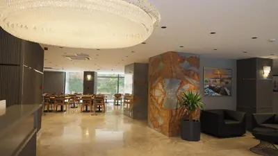 a large chandelier in a room with tables and chairs at The Galata Glory Hotel in Istanbul