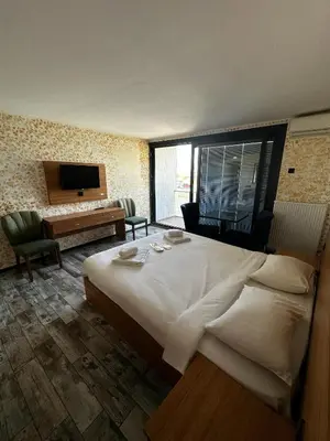 a hotel room with a large bed and a desk at Rüya Otel Şile in Sile