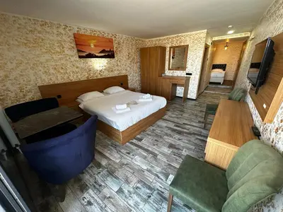 a hotel room with a bed and a table and chairs at Rüya Otel Şile in Sile