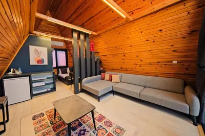 a living room with a couch and a table at Kerpe Bungalov Hotel in Kocaeli