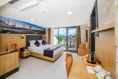 a hotel room with a bed and a table at Bulton Hotel Airport in Arnavutköy