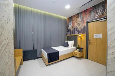a bedroom with a bed and a wall with a mural at Bulton Hotel Airport in Arnavutköy
